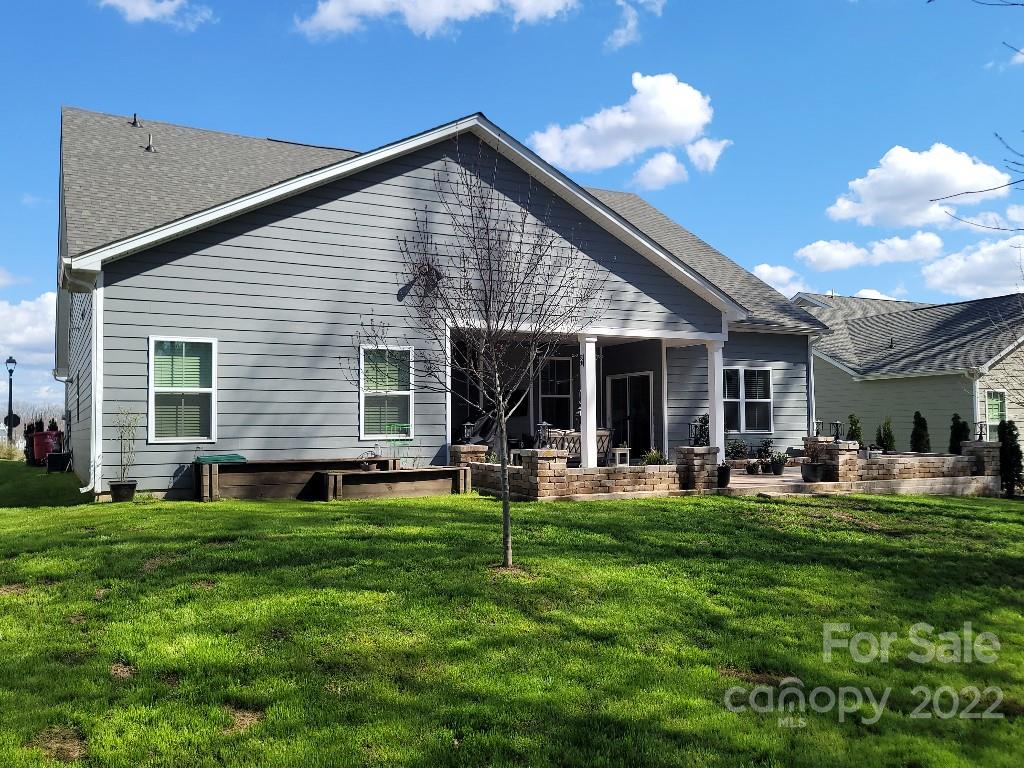 14100 Sunnyhill Grove Road Davidson, NC 28036 - Photo 13 of 18 a front view of house with yard outdoor seating and garage