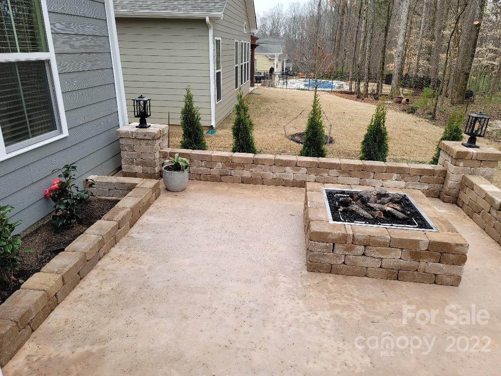 14100 Sunnyhill Grove Road Davidson, NC 28036 - Photo 15 of 18 a view of a couches and fire pit in the patio