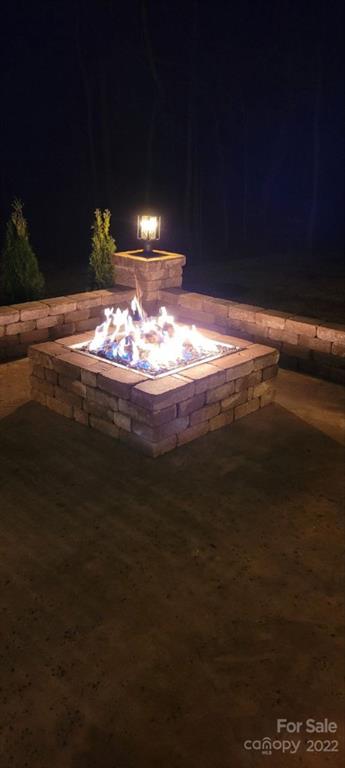14100 Sunnyhill Grove Road Davidson, NC 28036 - Photo 16 of 18 a view of an empty room with a fireplace