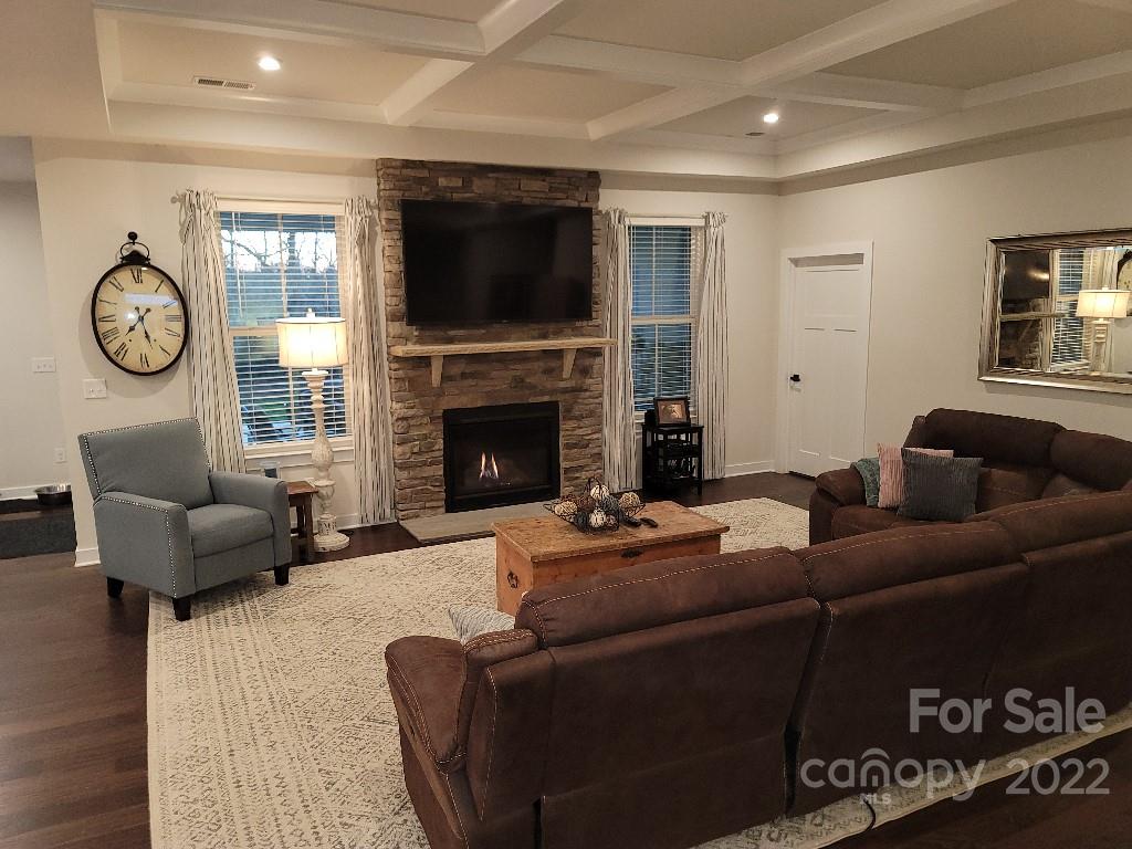14100 Sunnyhill Grove Road Davidson, NC 28036 - Photo 7 of 18 a living room with furniture a fireplace and a flat screen tv