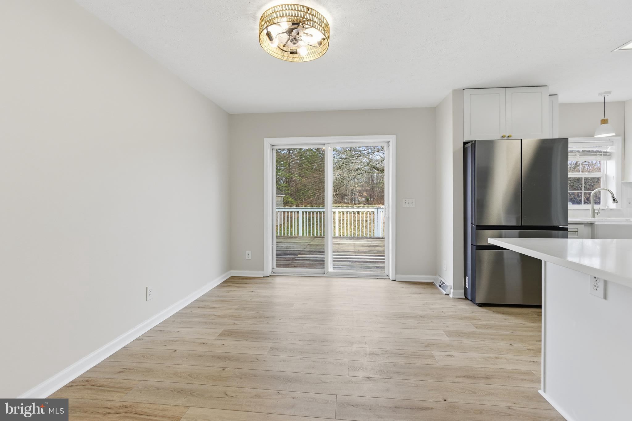 115 Gambrills Road Severn, MD 21144 - Photo 15 of 41 a view of a kitchen with a sink a refrigerator and a stove top oven
