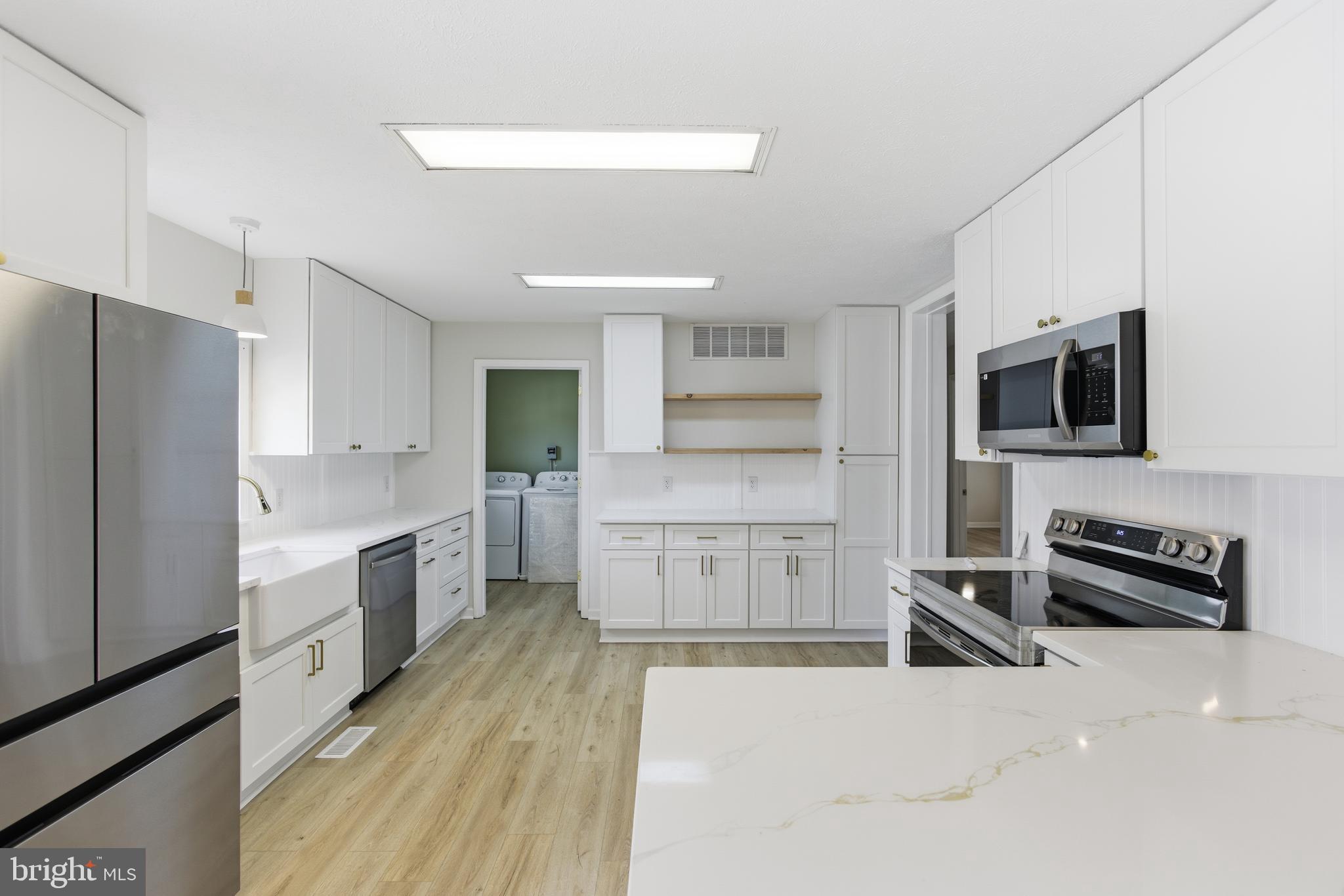 115 Gambrills Road Severn, MD 21144 - Photo 19 of 41 a kitchen with stainless steel appliances a refrigerator stove and microwave