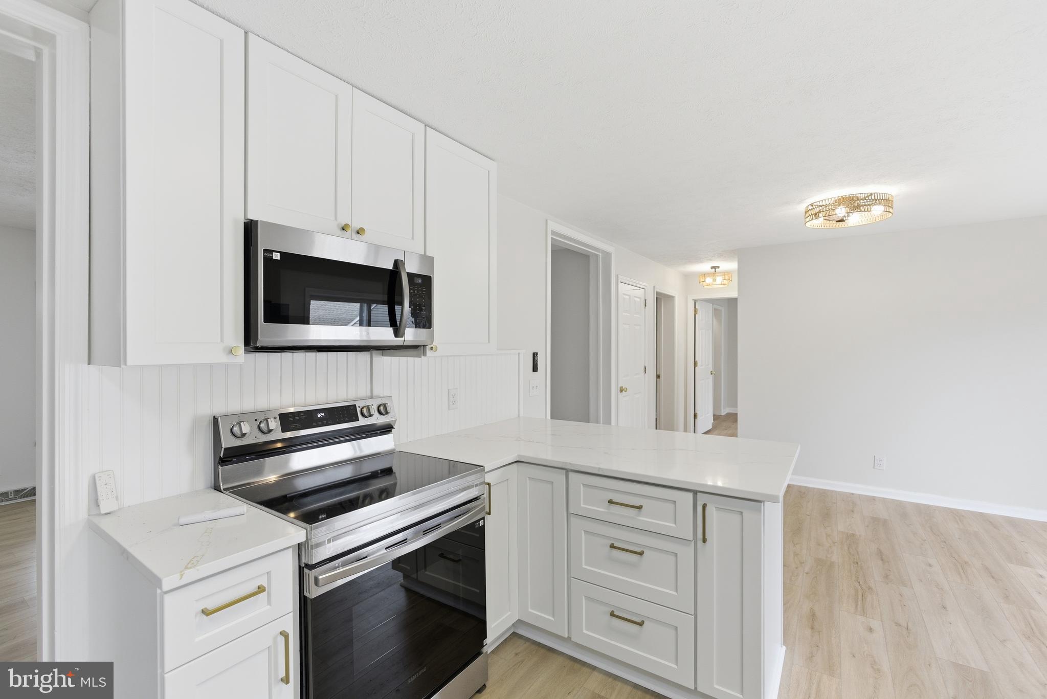 115 Gambrills Road Severn, MD 21144 - Photo 22 of 41 a kitchen with white cabinets stainless steel appliances and sink