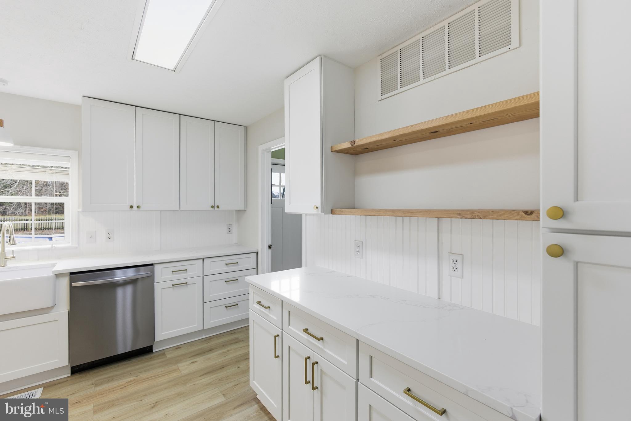 115 Gambrills Road Severn, MD 21144 - Photo 23 of 41 a kitchen with white cabinets and white appliances