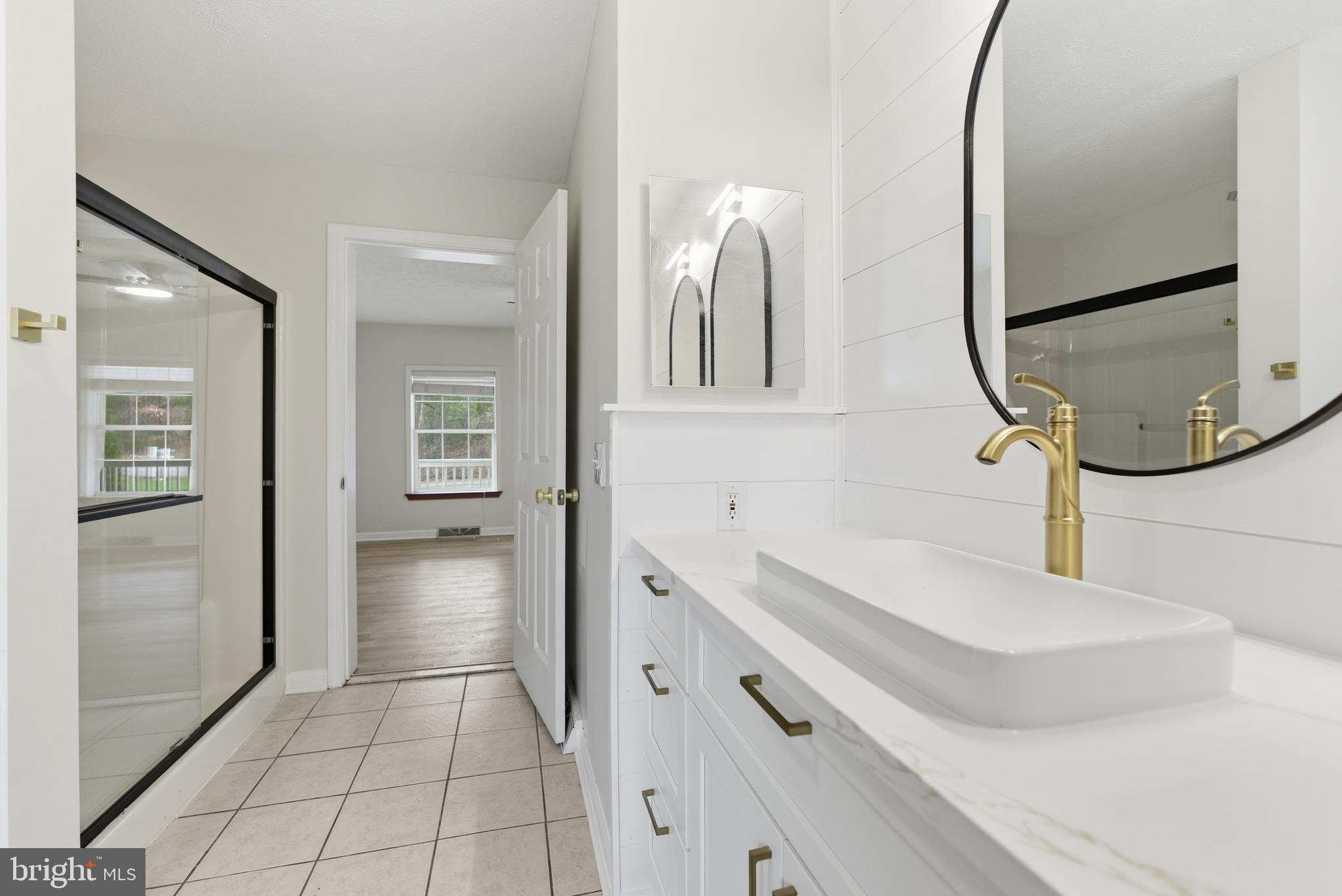 115 Gambrills Road Severn, MD 21144 - Photo 26 of 41 a en suite bathroom with a sink and a mirror