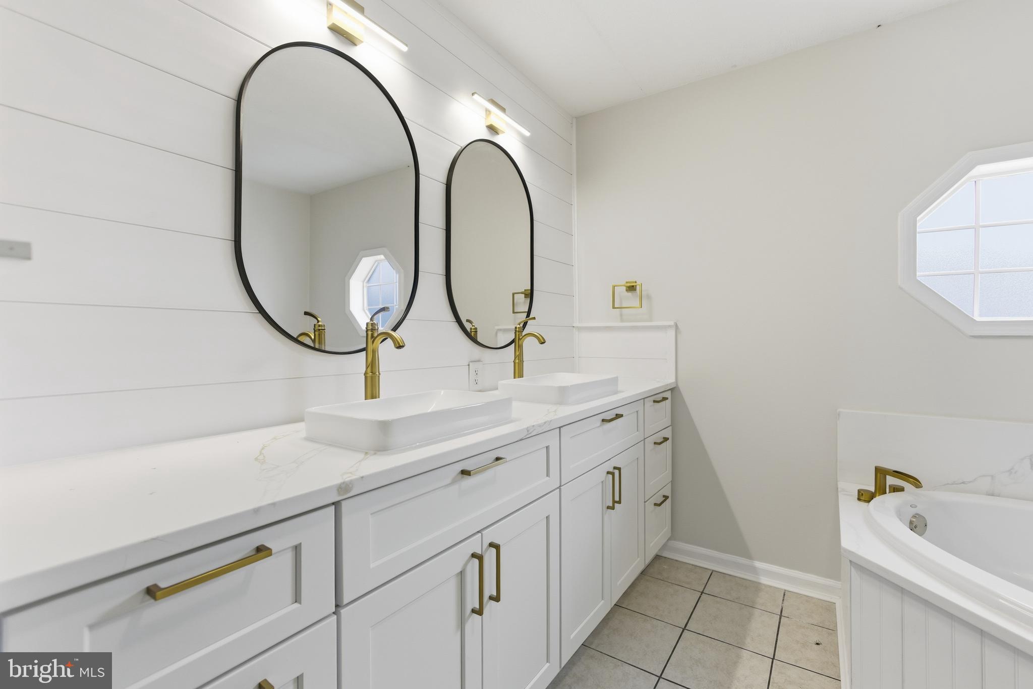 115 Gambrills Road Severn, MD 21144 - Photo 29 of 41 a bathroom with a sink and a mirror
