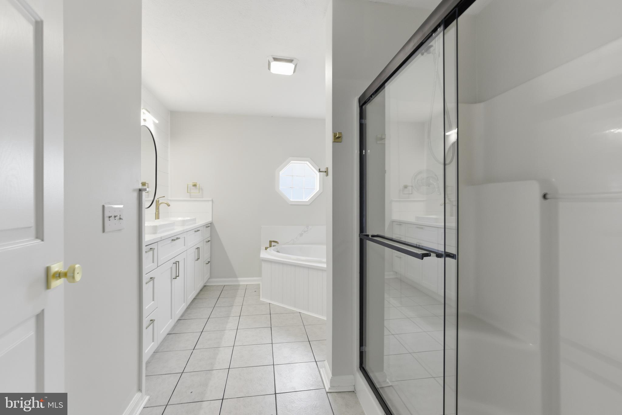 115 Gambrills Road Severn, MD 21144 - Photo 30 of 41 a spacious bathroom with a double vanity sink a mirror and a shower