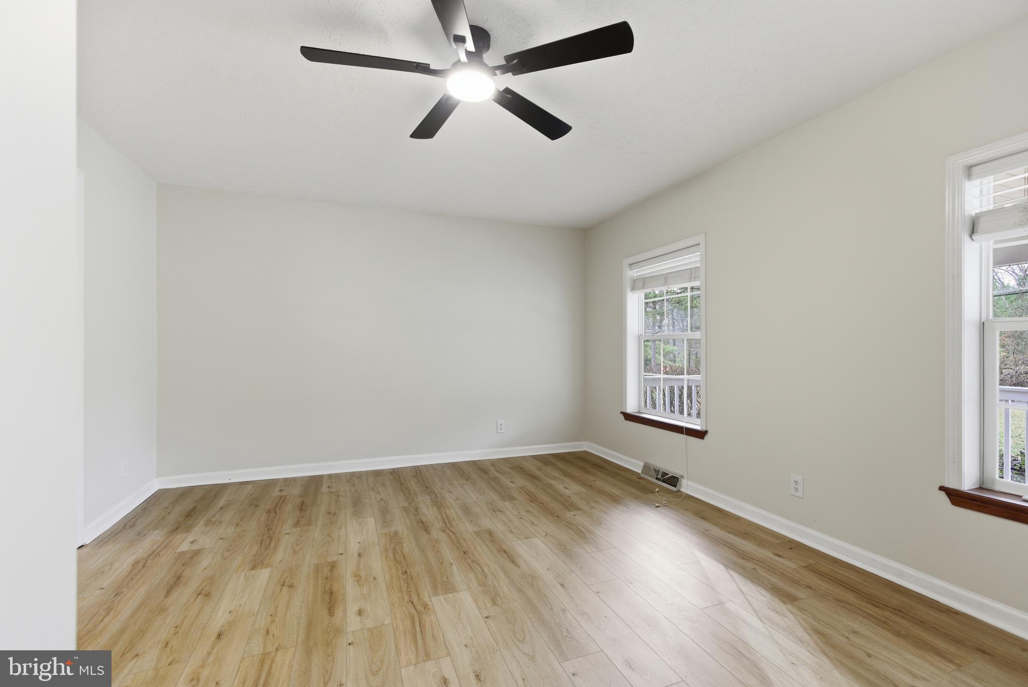 115 Gambrills Road Severn, MD 21144 - Photo 32 of 41 an empty room with a window and a ceiling fan