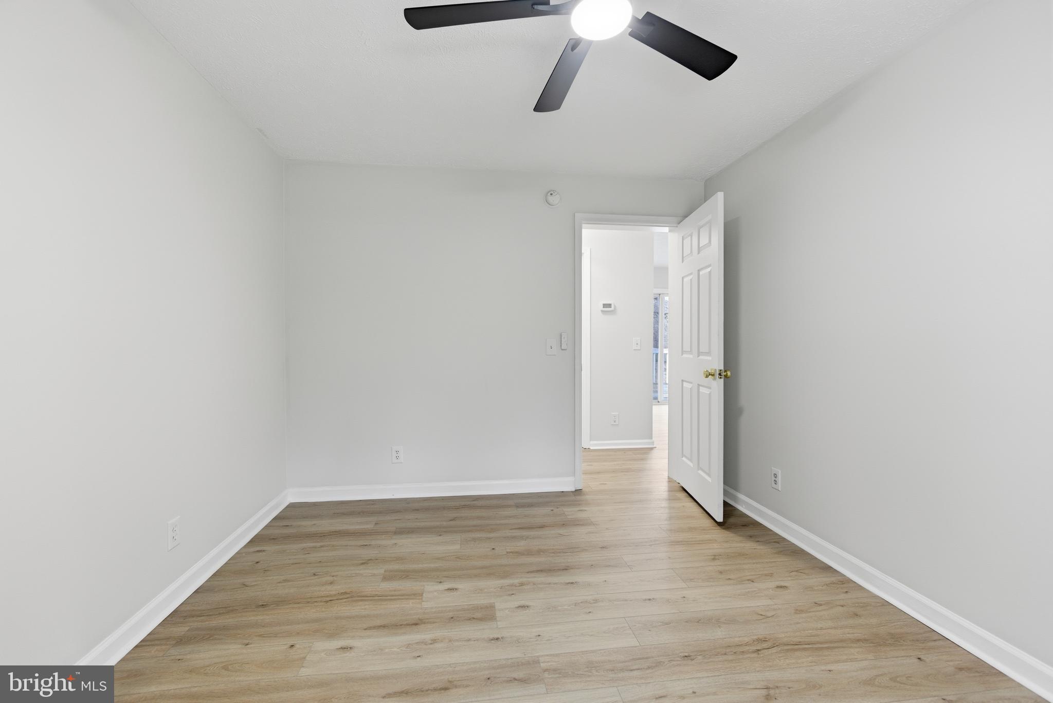 115 Gambrills Road Severn, MD 21144 - Photo 8 of 41 an empty room with wooden floor and ceiling fan