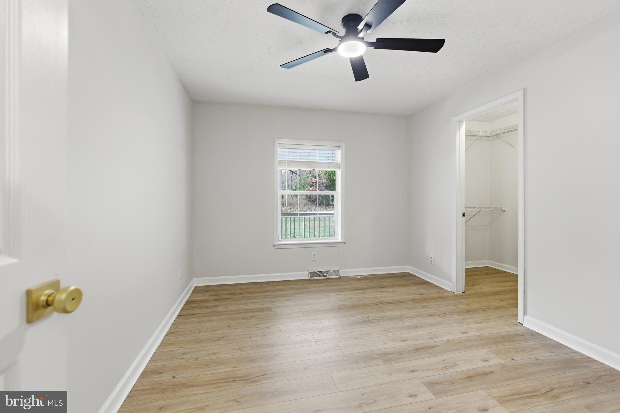 115 Gambrills Road Severn, MD 21144 - Photo 9 of 41 wooden floor in an empty room with a window