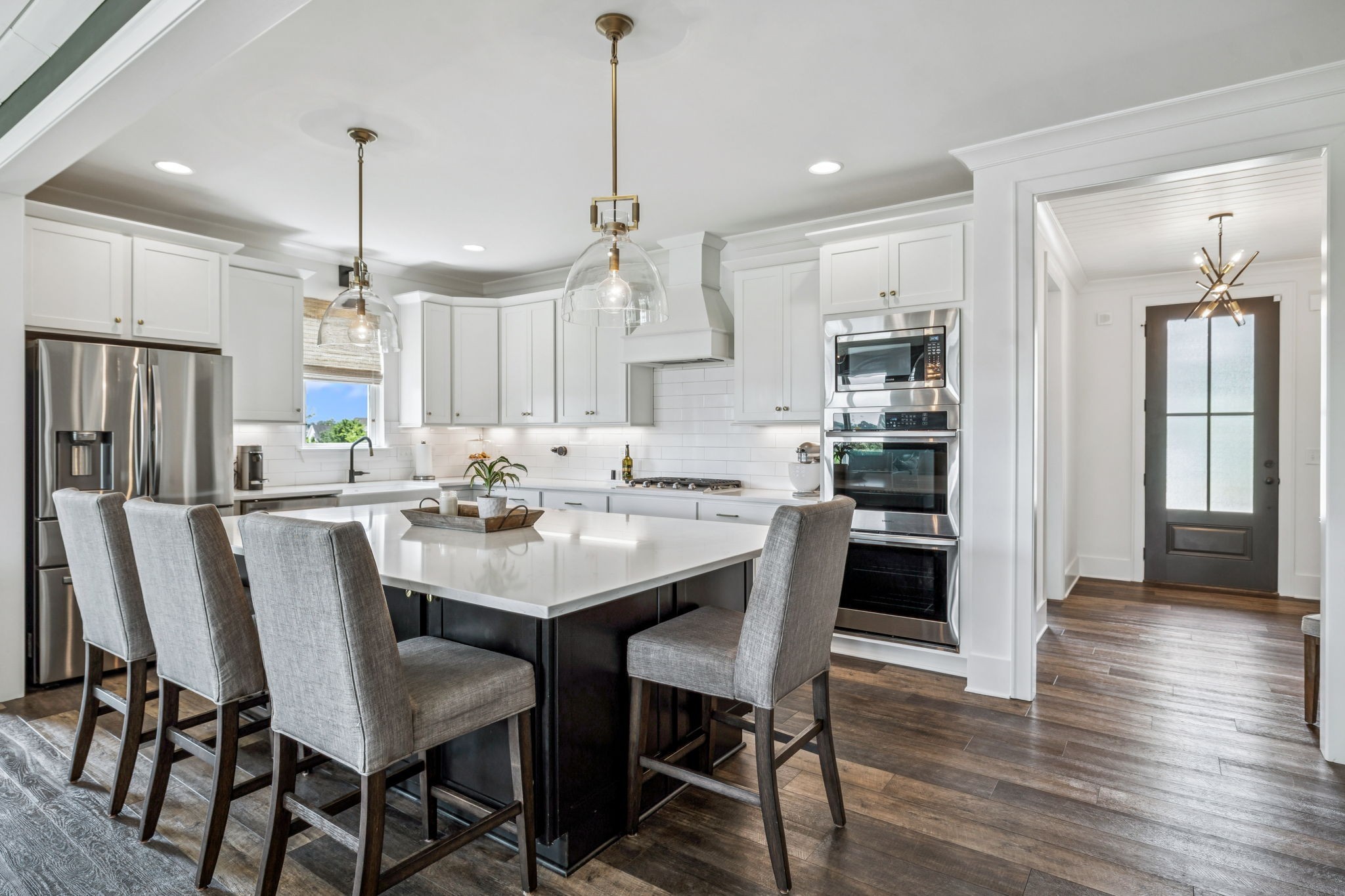 7204 Ludlow Drive College Grove, TN 37046 - Photo 13 of 59 a kitchen with stainless steel appliances a dining table chairs and wooden floor