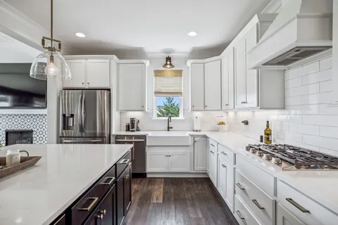 a kitchen with sink stove and cabinets