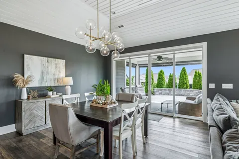 a bathroom with a tub shower sink vanity and mirror