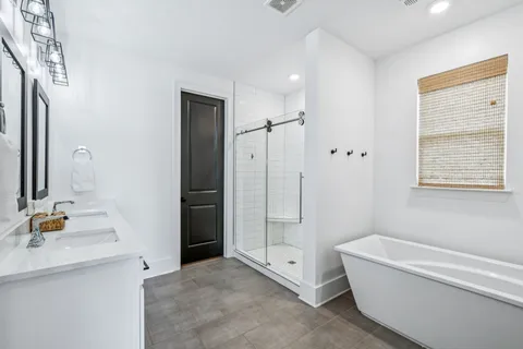 a en suite bathroom with a shower a sink and a mirror