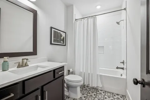 a living room with furniture and a lamp