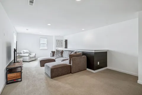 a bathroom with a sink a toilet a mirror and shower curtain