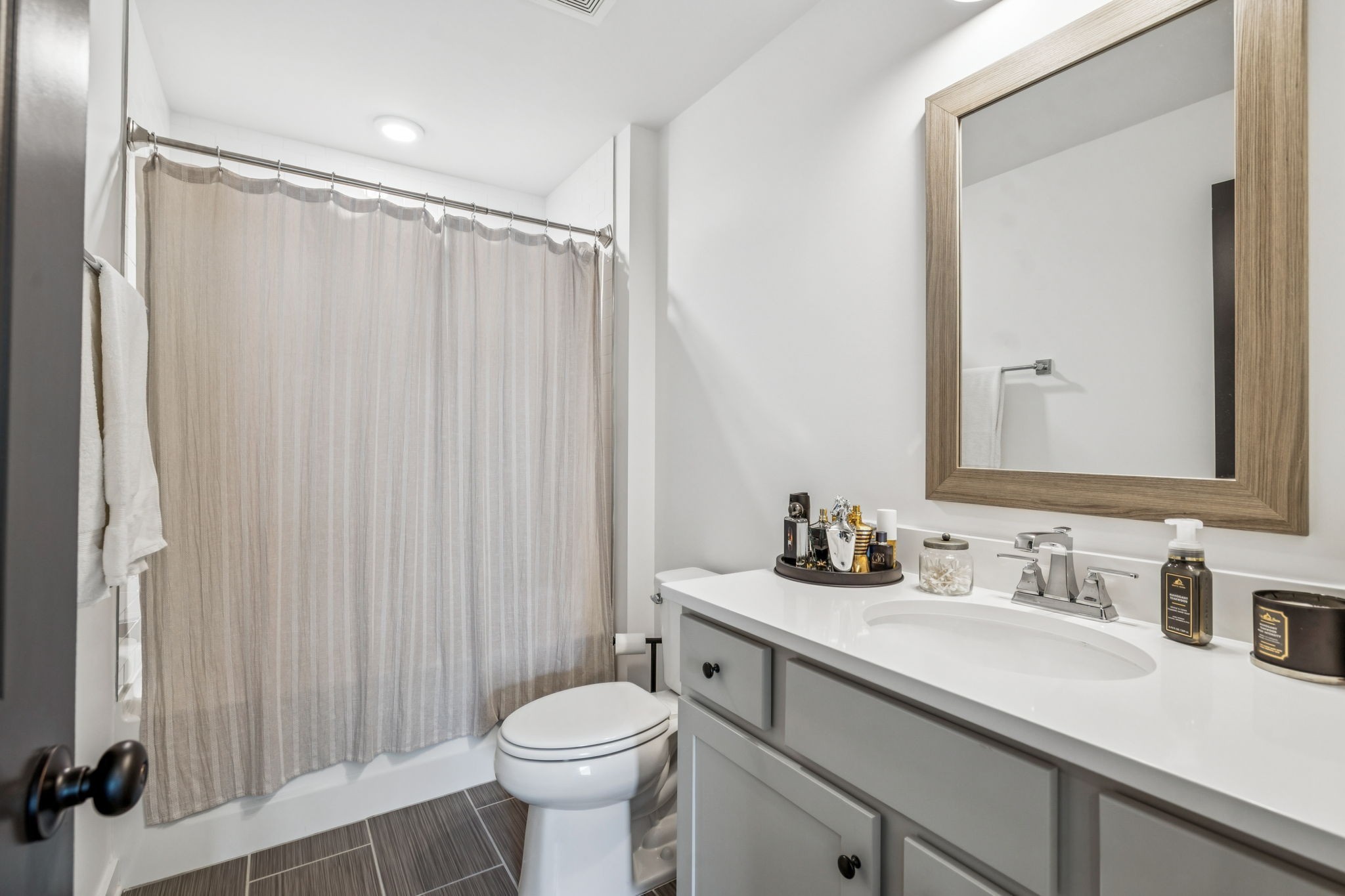 7204 Ludlow Drive College Grove, TN 37046 - Photo 31 of 59 a bathroom with a sink a toilet a mirror and shower curtain