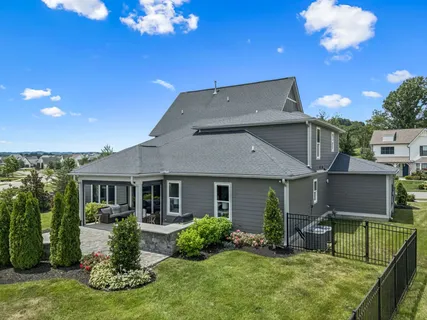 an aerial view of a residential houses with outdoor space
