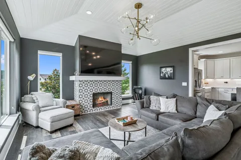 a living room with furniture and a fireplace
