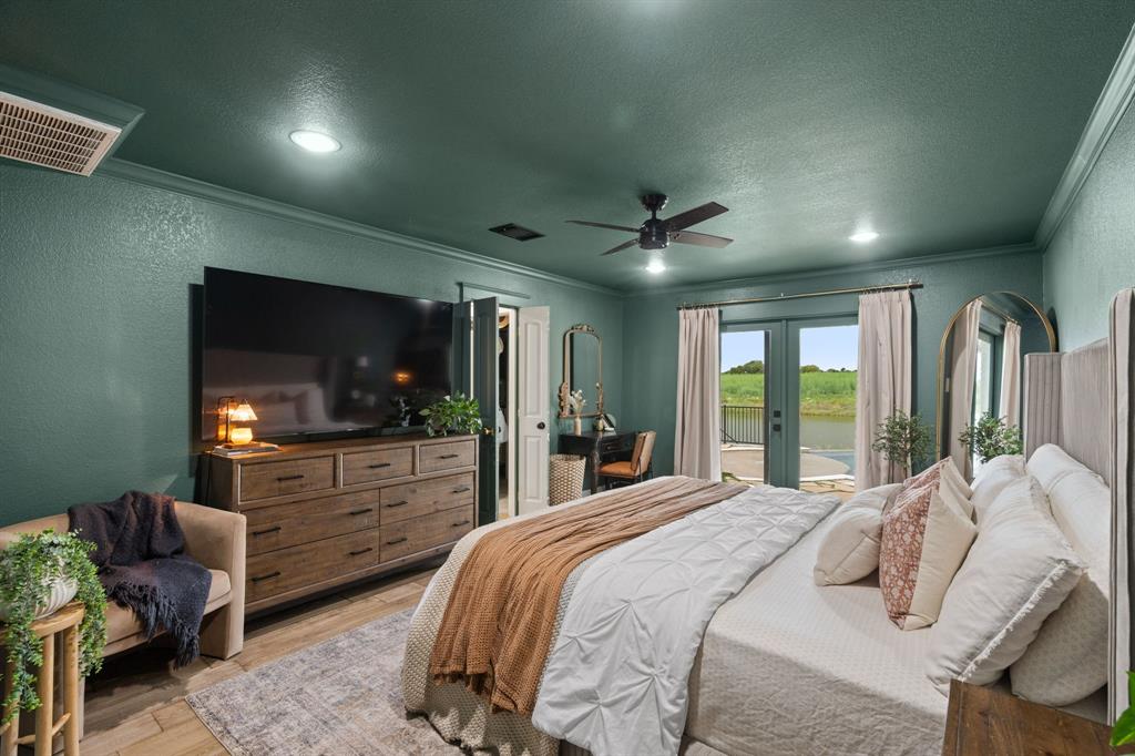 2402 Country Club Road Ennis, TX 75119 - Photo 11 of 33 a bedroom with a bed window and a television