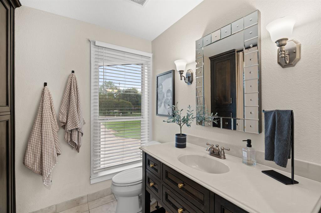 2402 Country Club Road Ennis, TX 75119 - Photo 15 of 33 a bathroom with a double vanity sink and mirror