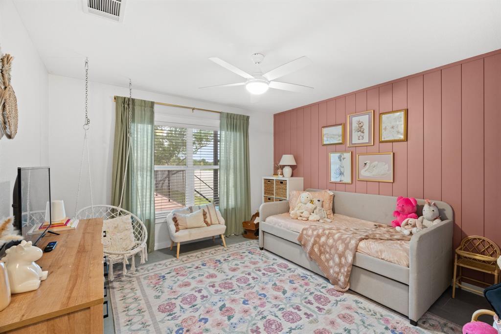 2402 Country Club Road Ennis, TX 75119 - Photo 16 of 33 a bedroom with a bed and wooden floor