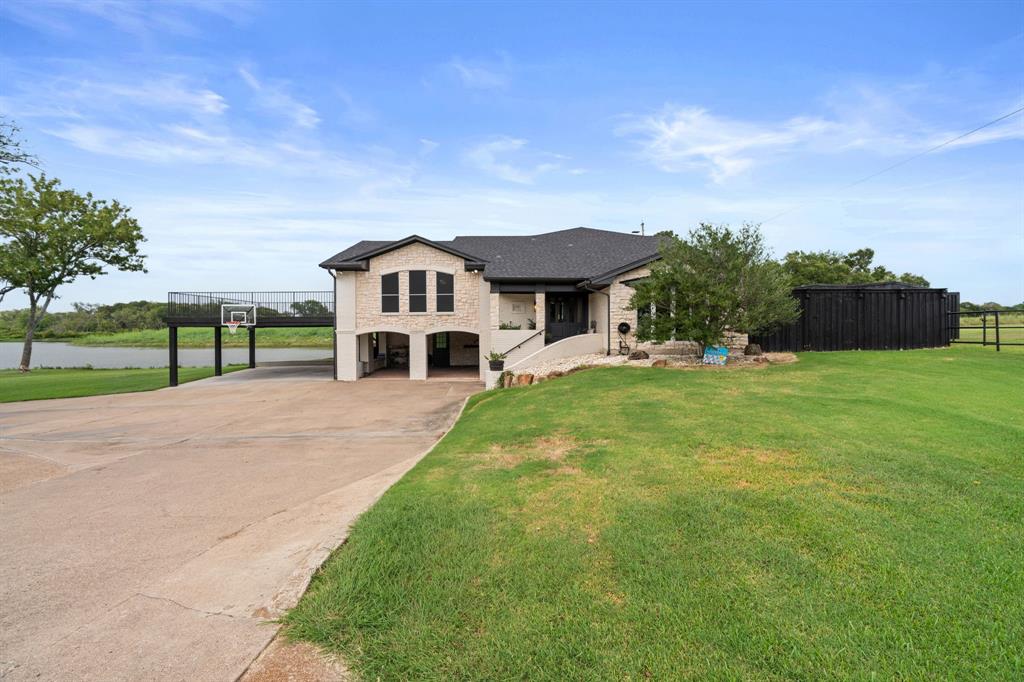 2402 Country Club Road Ennis, TX 75119 - Photo 2 of 33 a front view of a house with a yard
