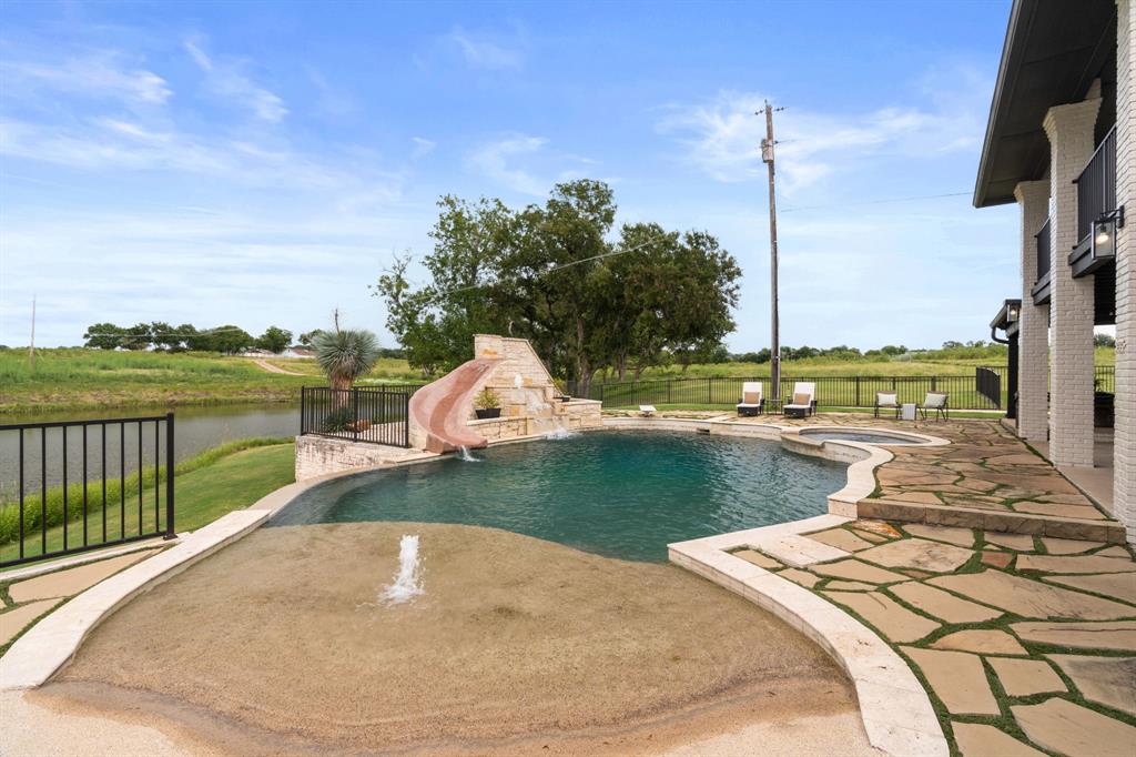 2402 Country Club Road Ennis, TX 75119 - Photo 27 of 33 a view of a swimming pool with a lake view