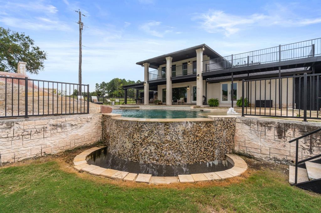 2402 Country Club Road Ennis, TX 75119 - Photo 28 of 33 a view of a house with a small yard and wooden fence