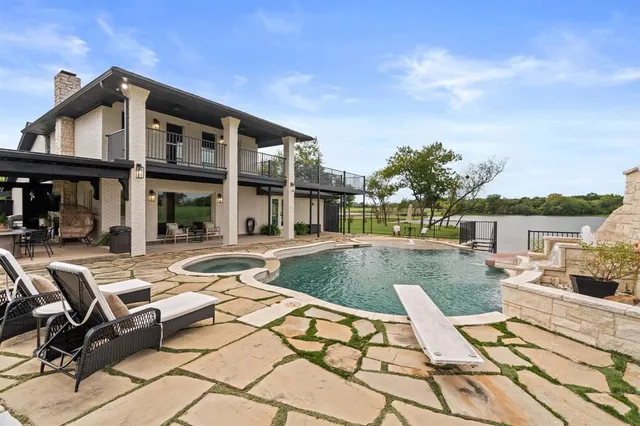 a view of a house with swimming pool and sitting area