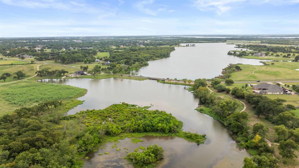 2402 Country Club Road Ennis, TX 75119 - Photo 31 of 33 a view of a lake with a city