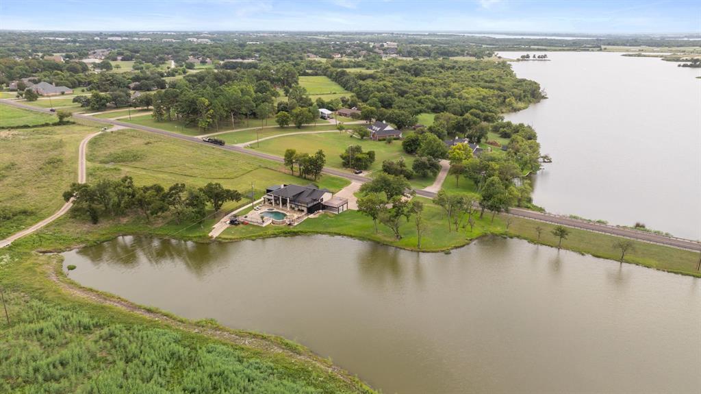 2402 Country Club Road Ennis, TX 75119 - Photo 32 of 33 an aerial view of a house with a lake view
