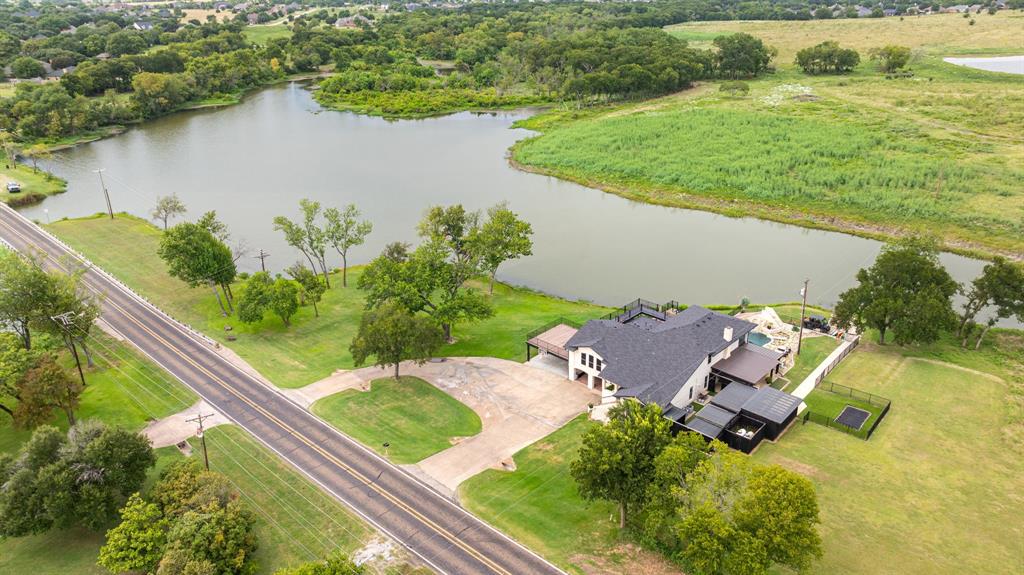 2402 Country Club Road Ennis, TX 75119 - Photo 33 of 33 an aerial view of a house with a yard and lake view