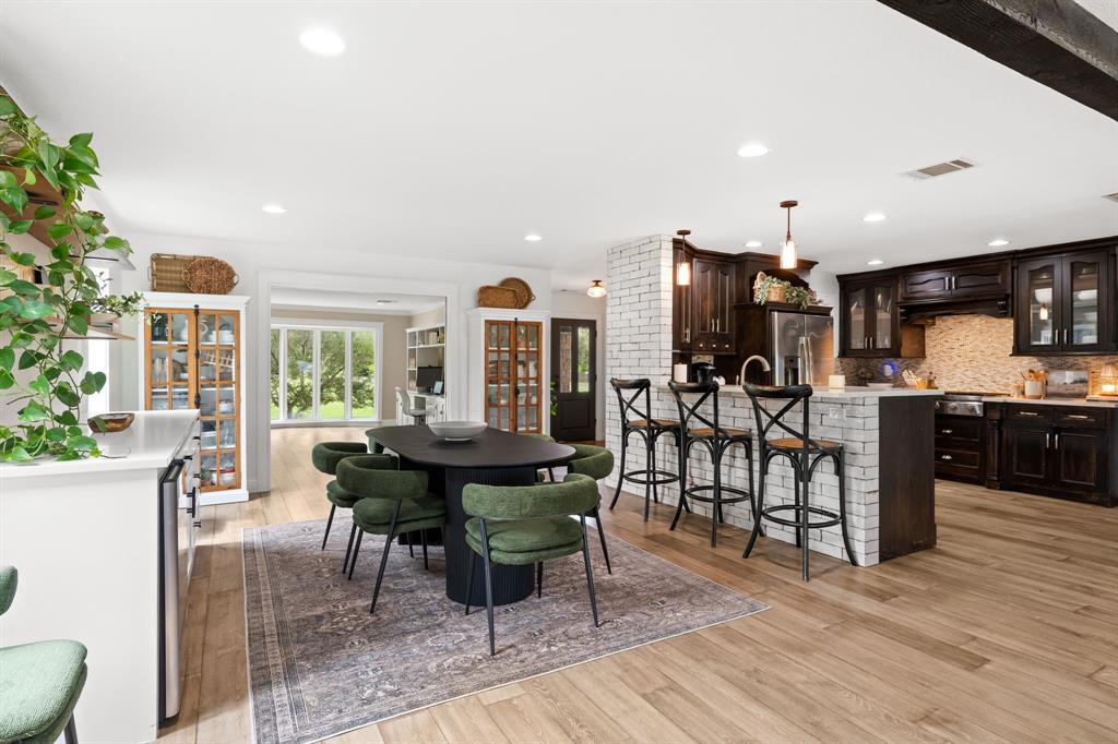 2402 Country Club Road Ennis, TX 75119 - Photo 8 of 33 a view of a dining room with furniture and wooden floor