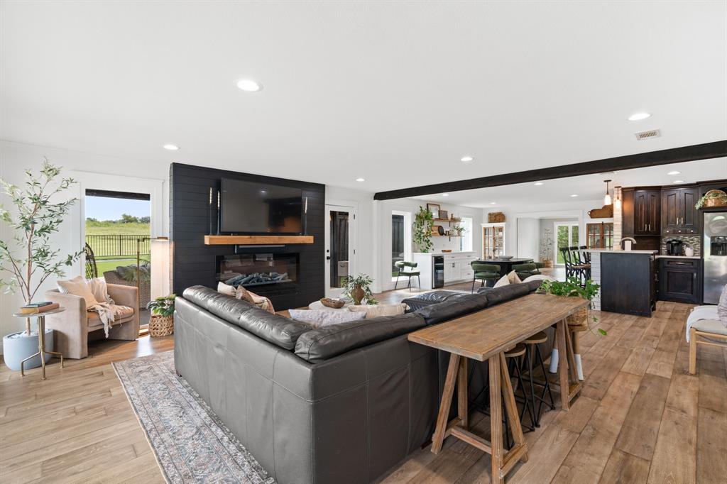 2402 Country Club Road Ennis, TX 75119 - Photo 10 of 33 a living room with fireplace furniture and a flat screen tv