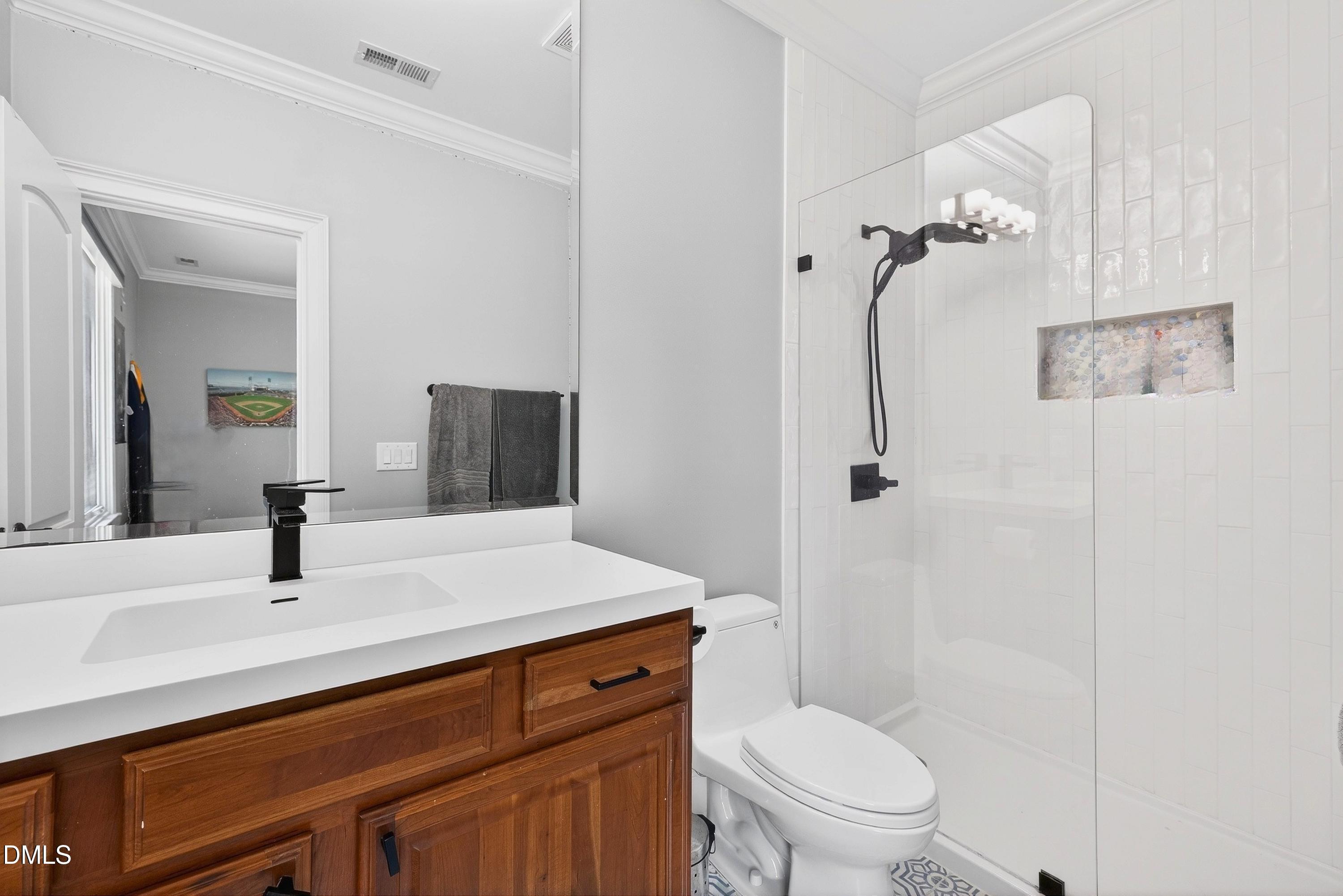 6701 Foxfire Place Raleigh, NC 27615 - Photo 45 of 67 a bathroom with a sink a toilet and shower