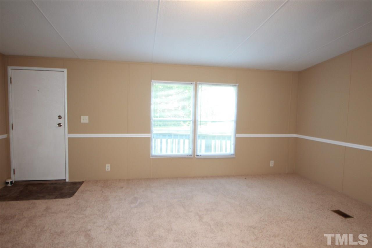 353 Oliver Loop Road Roxboro, NC 27574 - Photo 2 of 11 an empty room with a window
