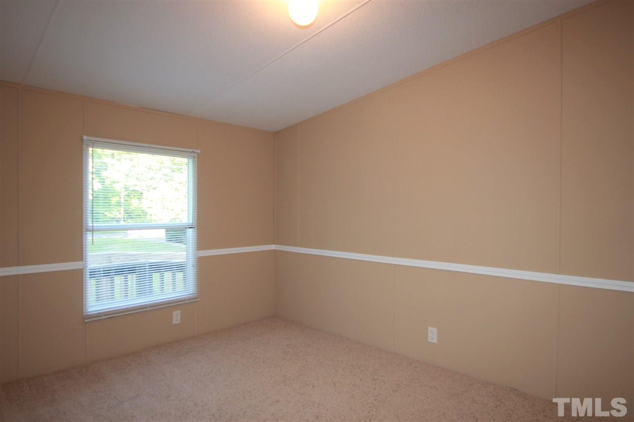353 Oliver Loop Road Roxboro, NC 27574 - Photo 7 of 11 an empty room with a window