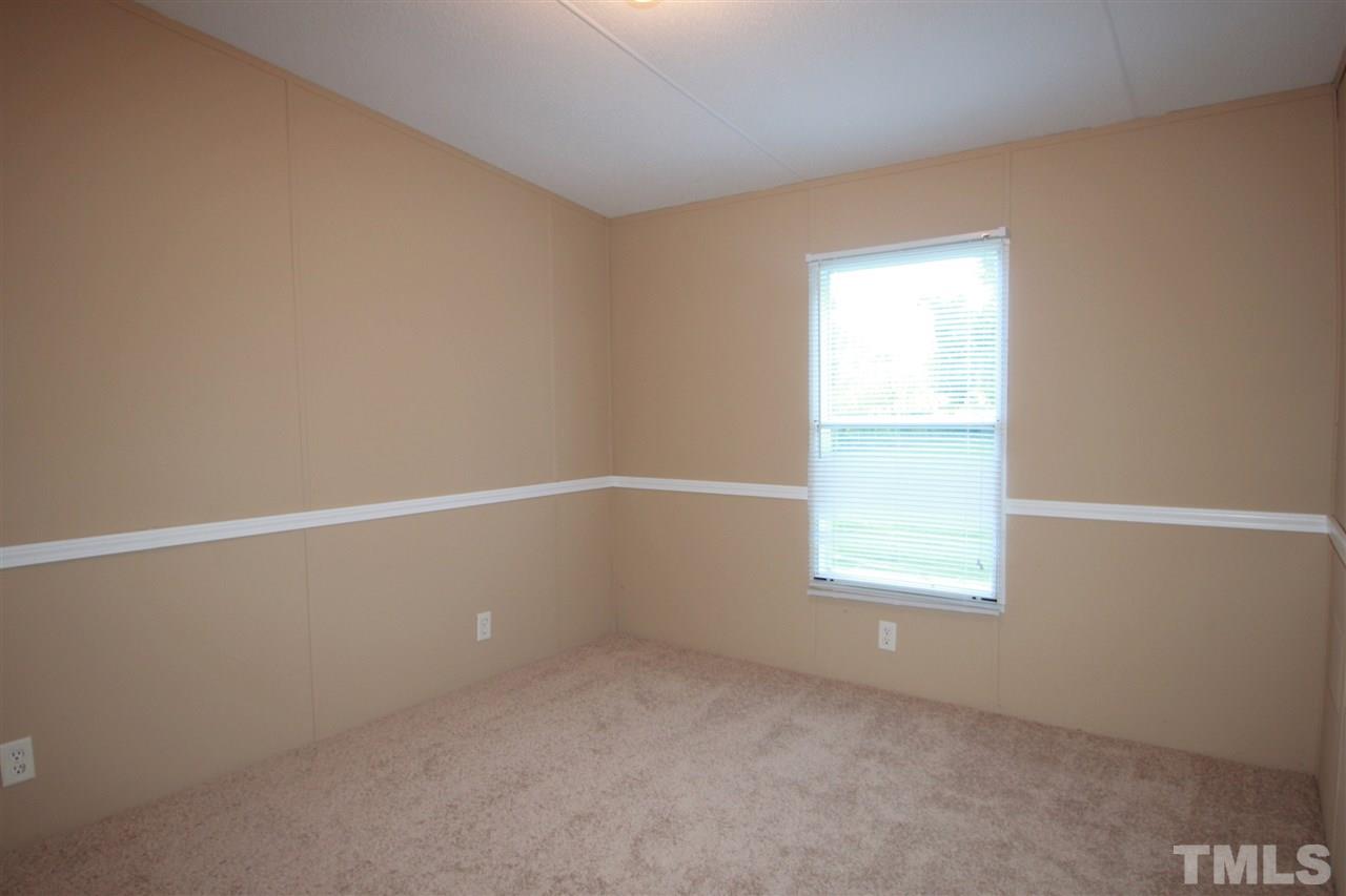 353 Oliver Loop Road Roxboro, NC 27574 - Photo 8 of 11 an empty room with a window