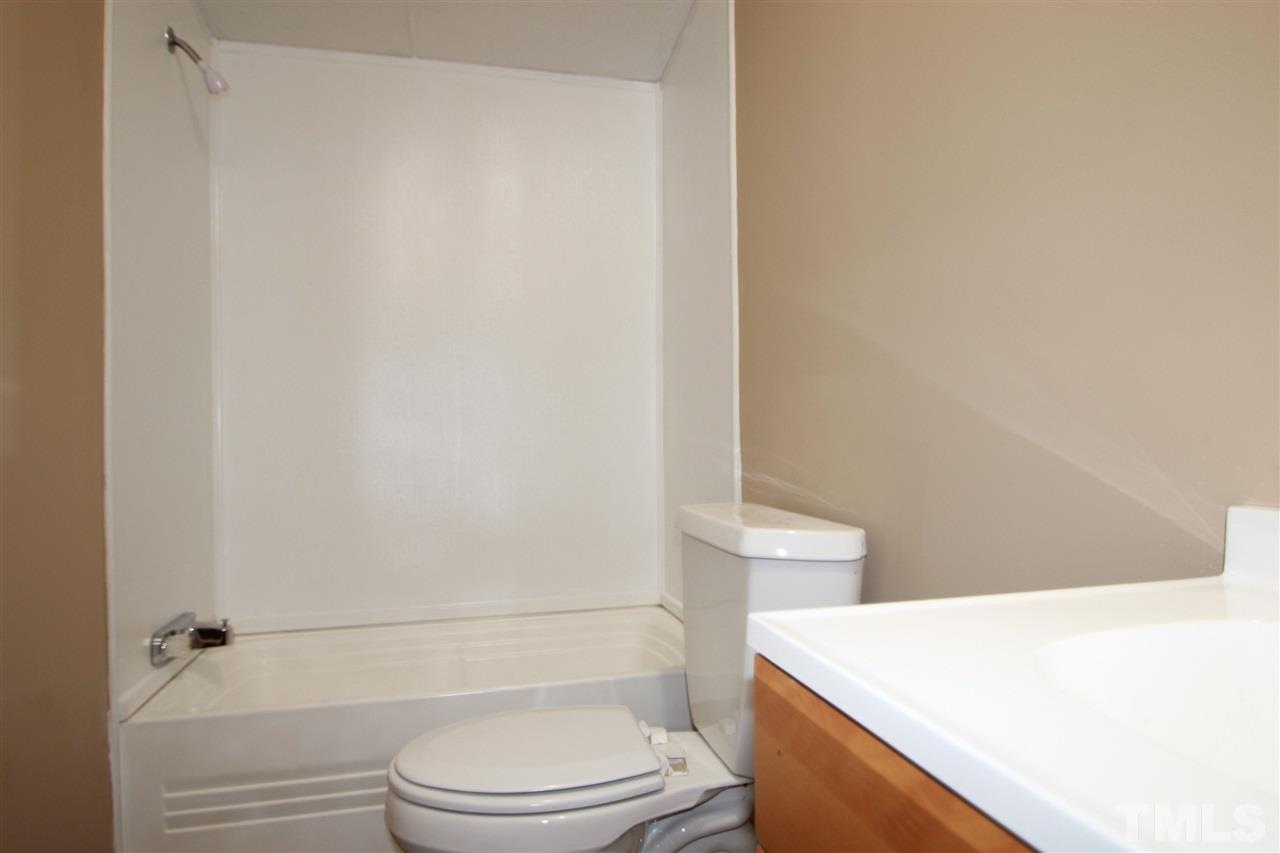 353 Oliver Loop Road Roxboro, NC 27574 - Photo 9 of 11 a bathroom with a toilet a sink and a bathtub
