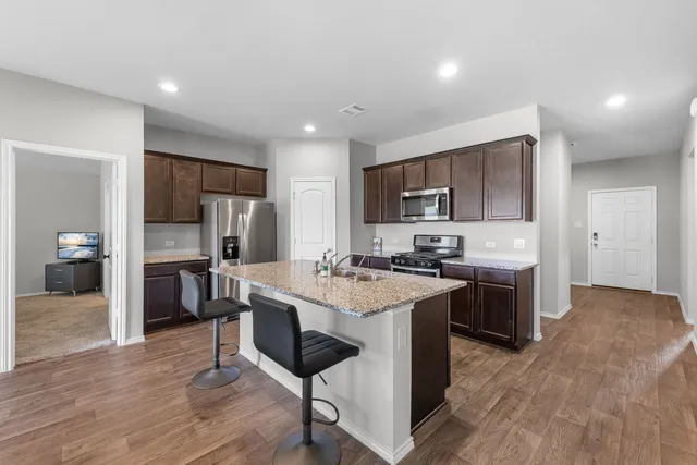 a kitchen with a sink cabinets and stainless steel appliances