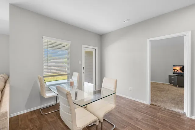 a view of a dining room with furniture and a window