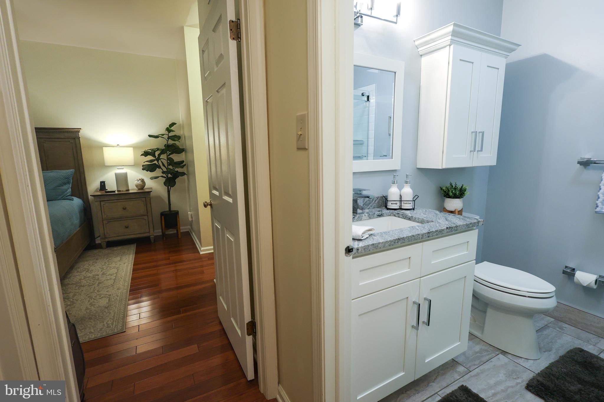 2602 Waterford Road Yardley, PA 19067 - Photo 11 of 33 a bathroom with a granite countertop sink a toilet and view of a bathroom