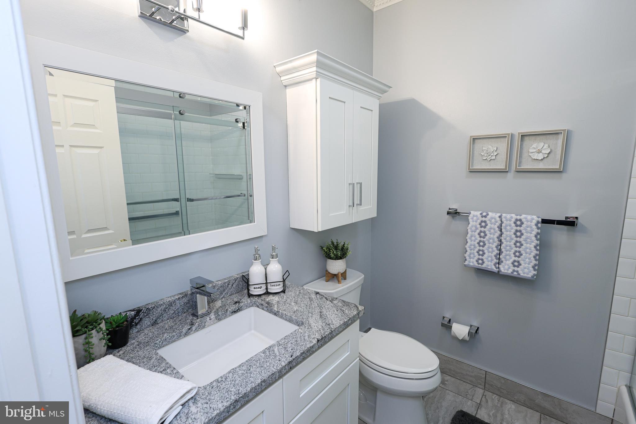 2602 Waterford Road Yardley, PA 19067 - Photo 12 of 33 a bathroom with a granite countertop sink toilet and mirror