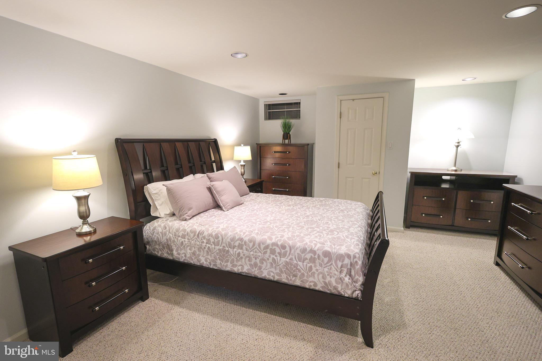 2602 Waterford Road Yardley, PA 19067 - Photo 25 of 33 a spacious bedroom with a bed and a lamp
