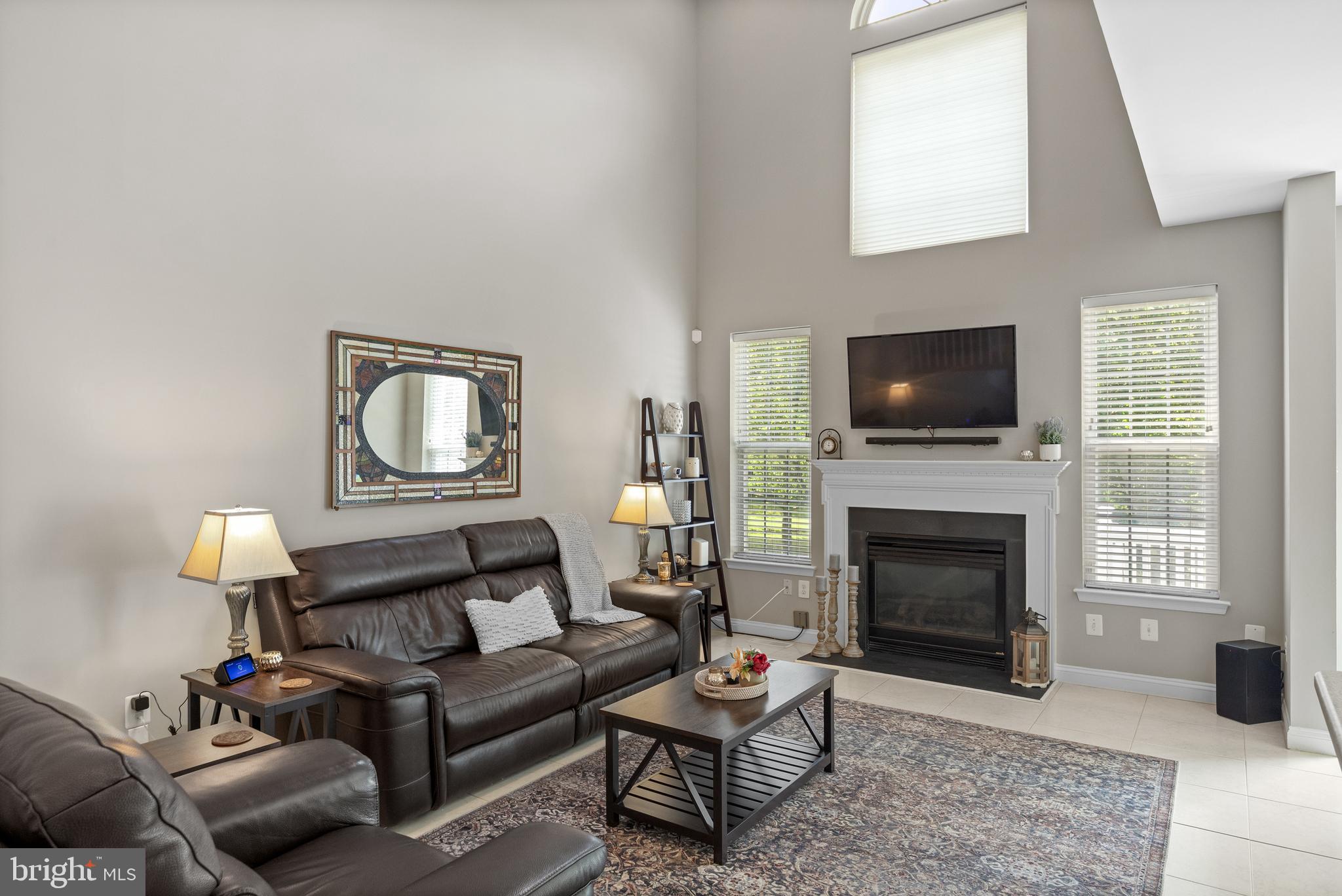 91 Weaver Drive Marlton, NJ 08053 - Photo 8 of 33 a living room with furniture a flat screen tv and a fireplace