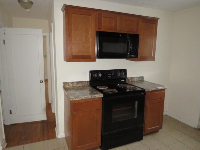 347 Clark Street Washington, PA 15301 - Photo 23 of 25 a kitchen with stainless steel appliances granite countertop a stove and a microwave