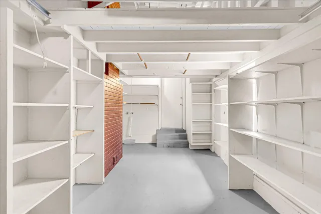 a view of walk in closet with empty racks