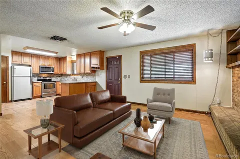 a living room with furniture and kitchen view