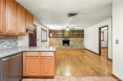 a kitchen with granite countertop a stove and cabinets
